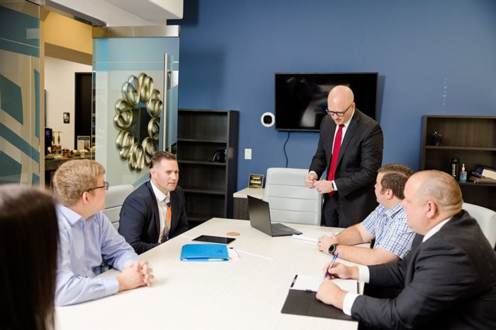 Conference room meeting between clients and Ernst Brown & Draper legal team